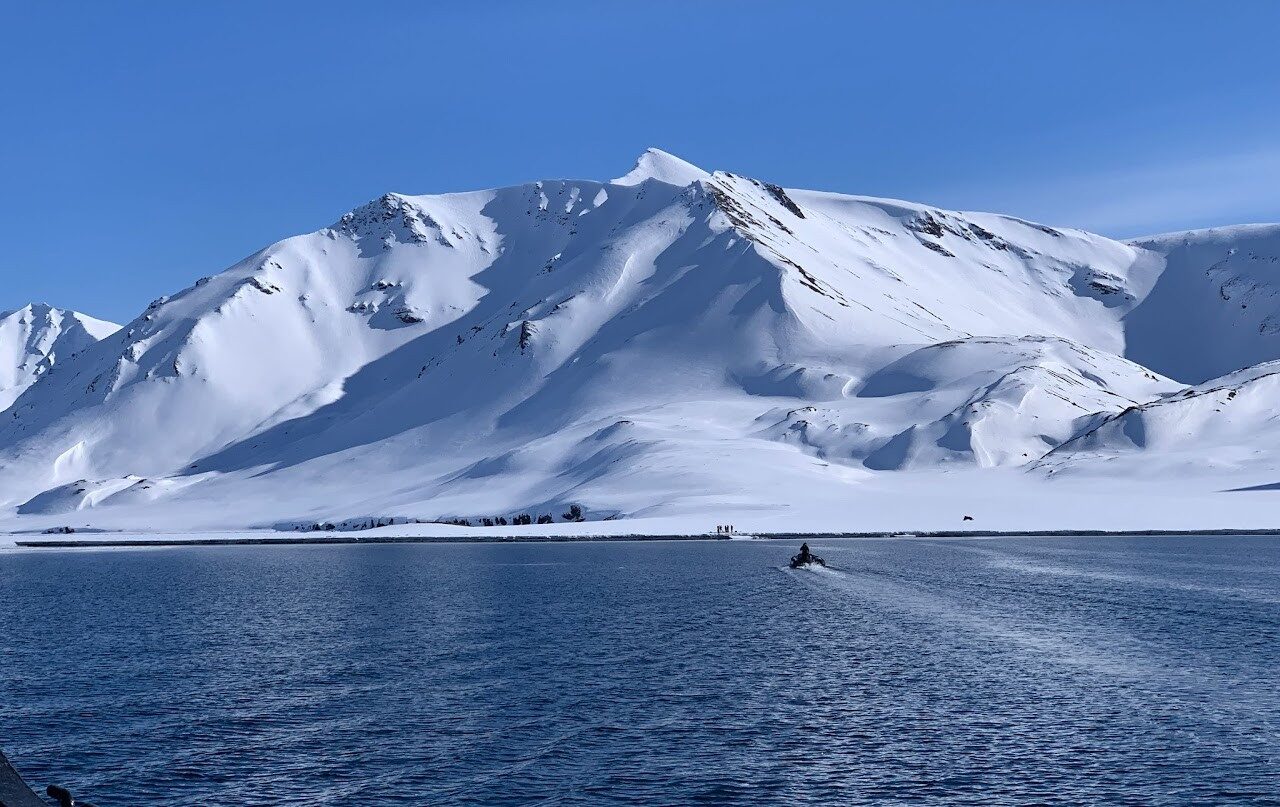 Sunlight across Svalbard's snowfields and fjords