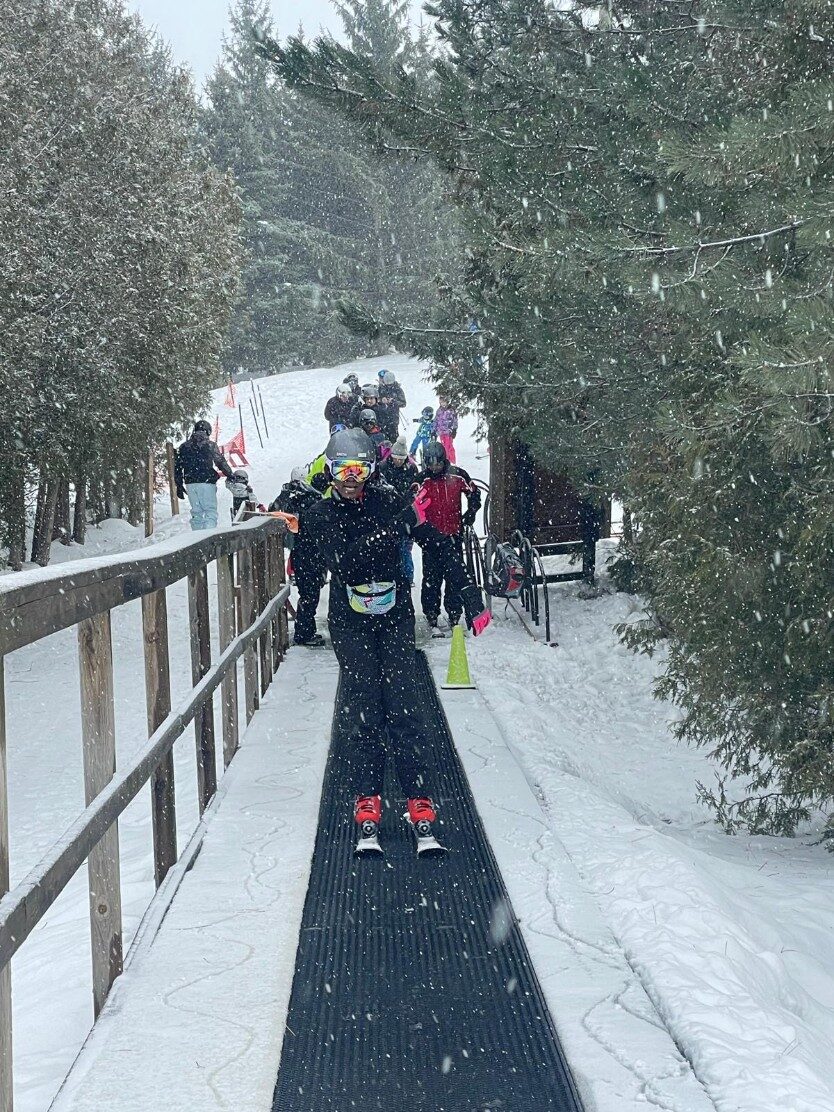 Skiers posing in the snow at the MLK Ski Festival Weekend