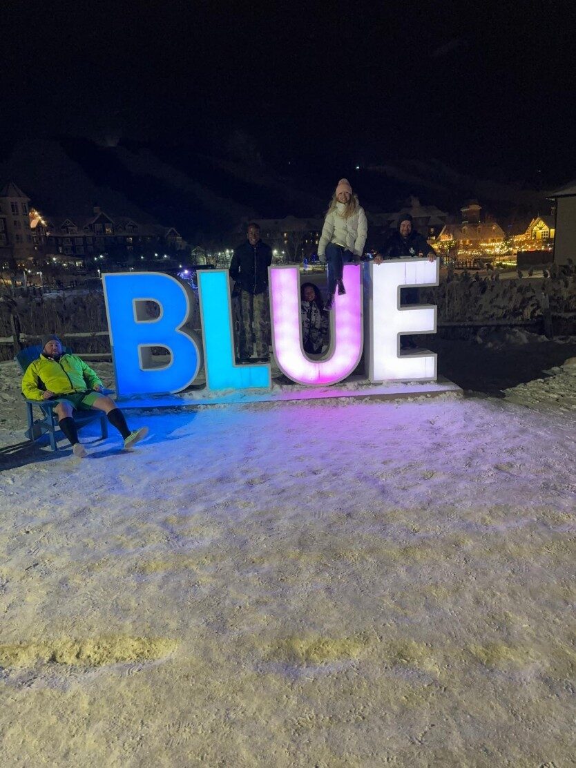 Member smiling on a snowy run at Blue Mountain