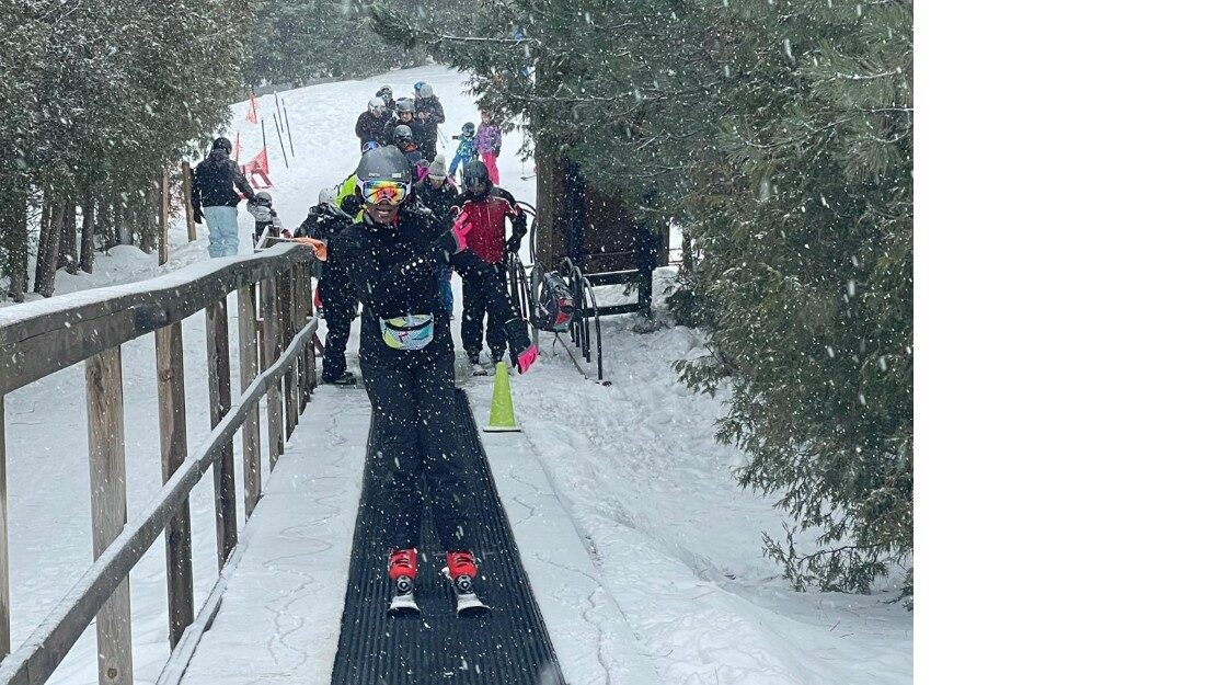 A Bermuda Snow member taking their first lesson on the magic carpet as snow falls